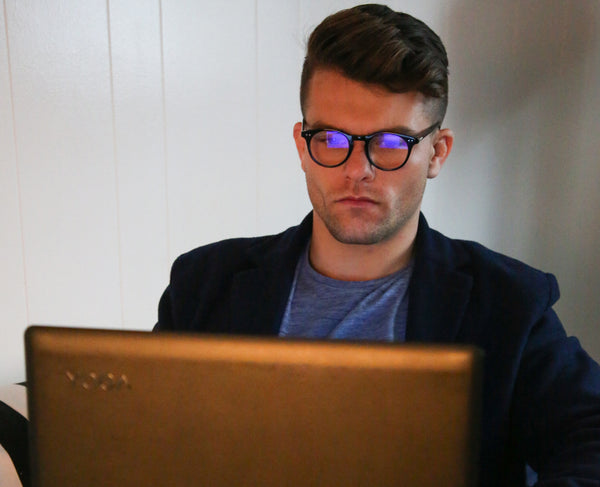 blue light glasses man on laptop